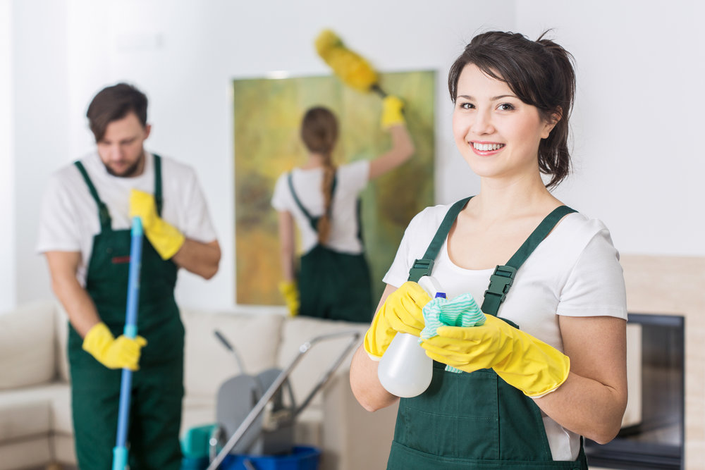 Group of young hard working professional cleaners in dirty apartment